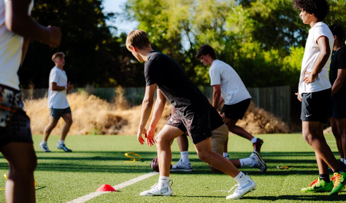A defensive back backpedals during a Pro Vision football practice