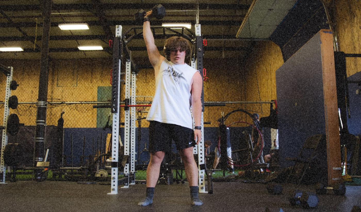 An athlete lifts in the weight room